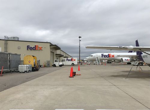 The image is of FedEx planes parked at the airport.